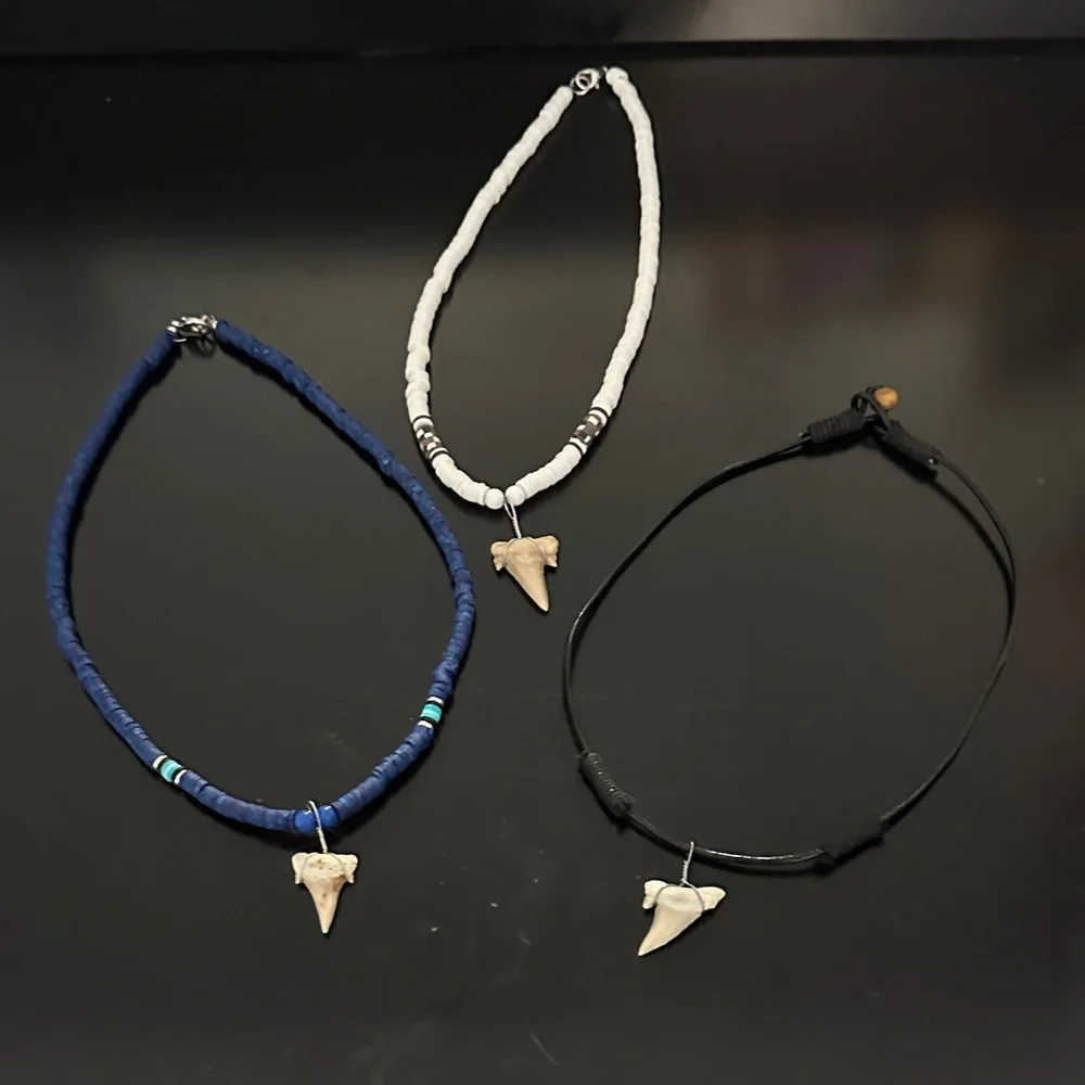 Three shark tooth necklaces